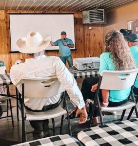 Members look at presenter at conference.